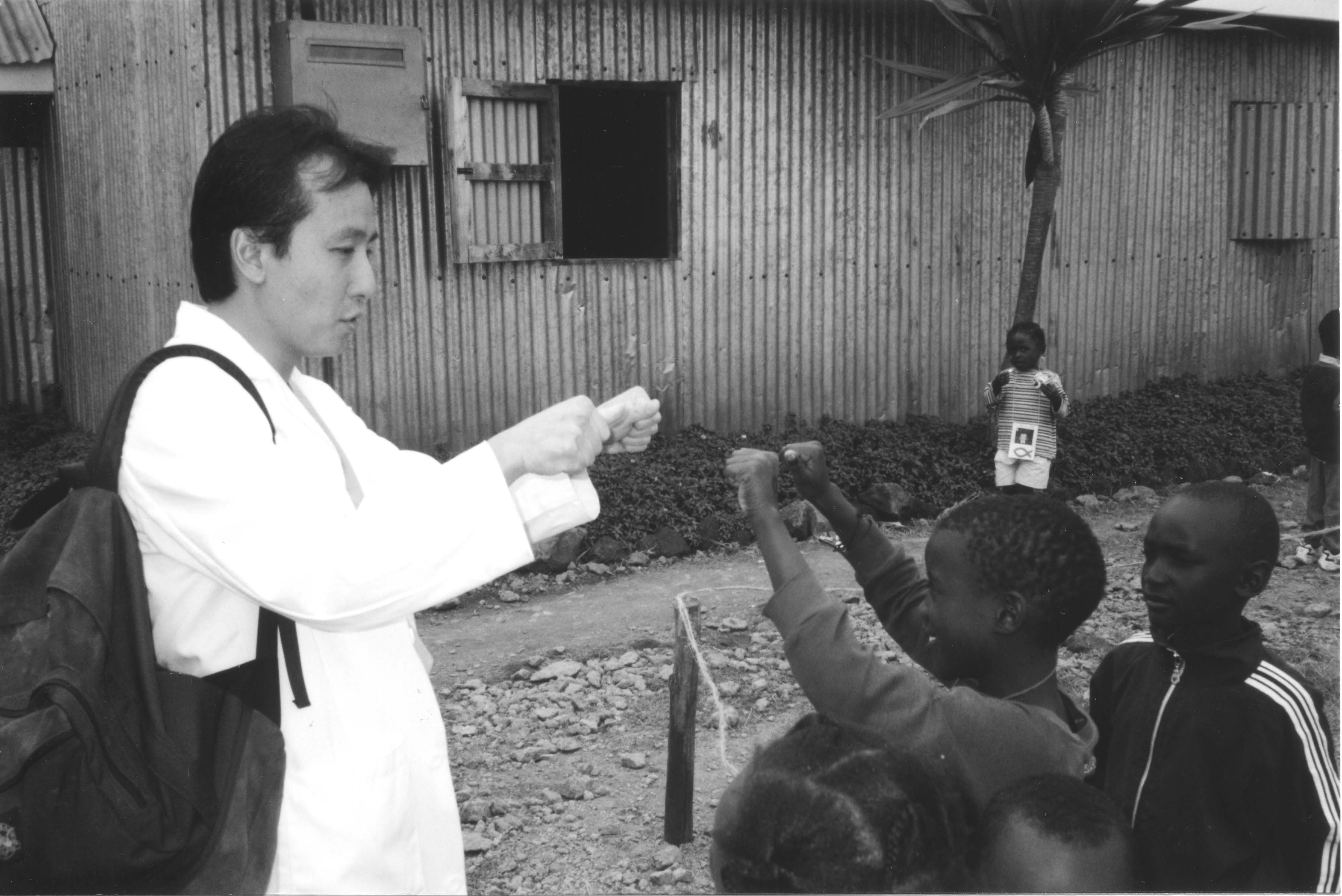 Dr. Lum on a medical mission in Nairobi, Kenya, in 2002, caring for children